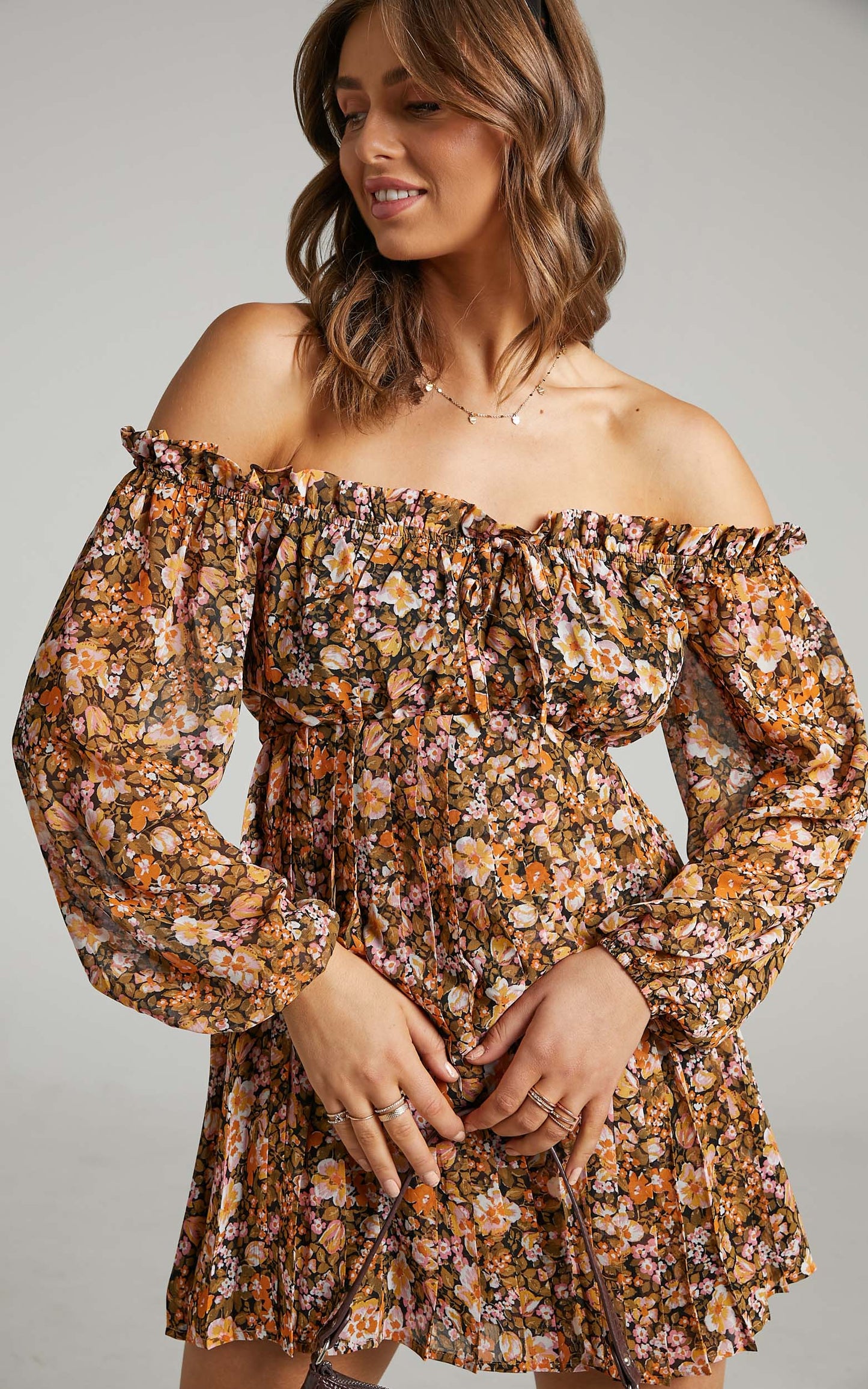 Aeryn Off Shoulder Pleated Mini Dress in Black Floral