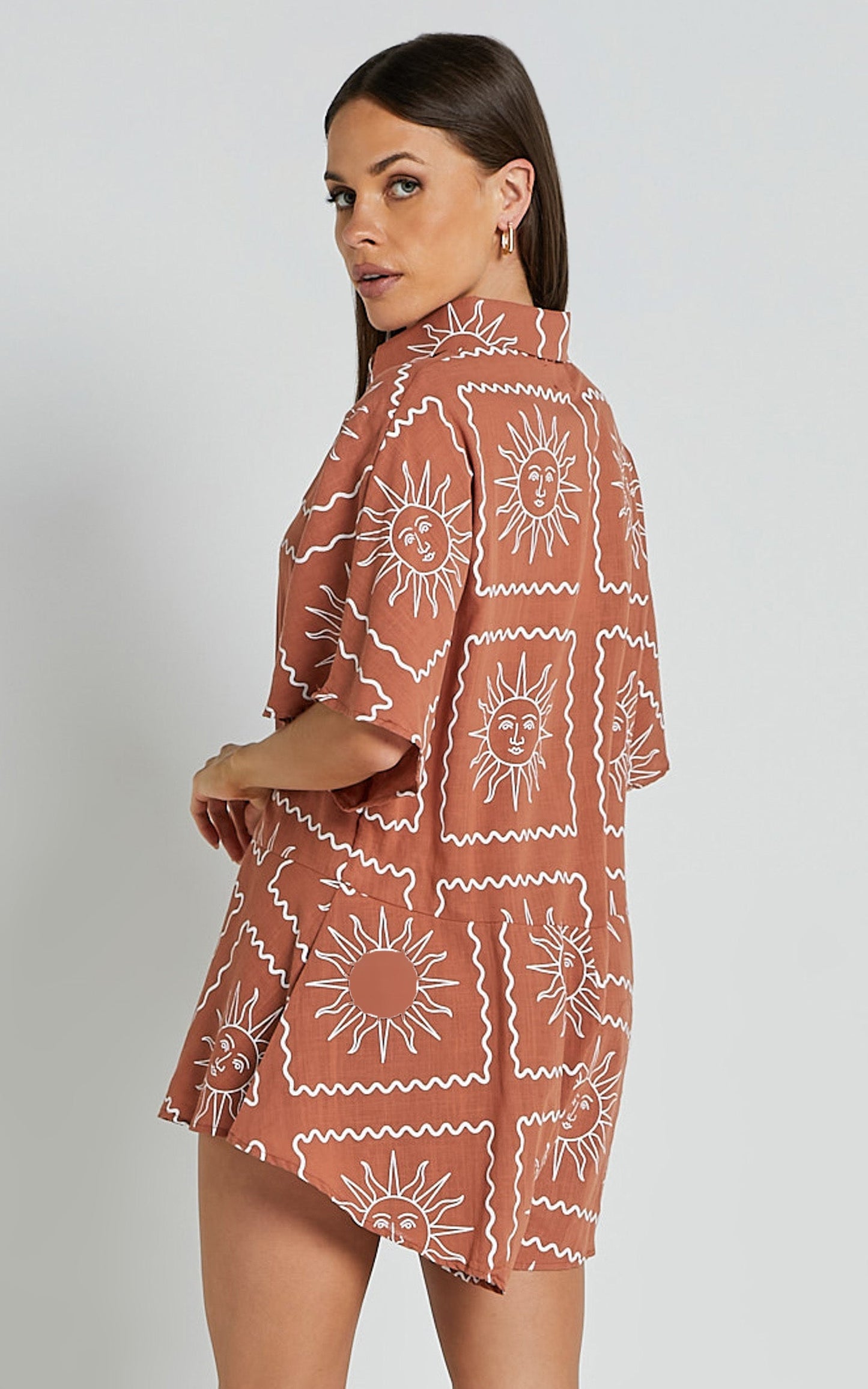 Amarie Playsuit- Short Sleeve Relaxed Linen Button Up Playsuit in Rust Sun Print