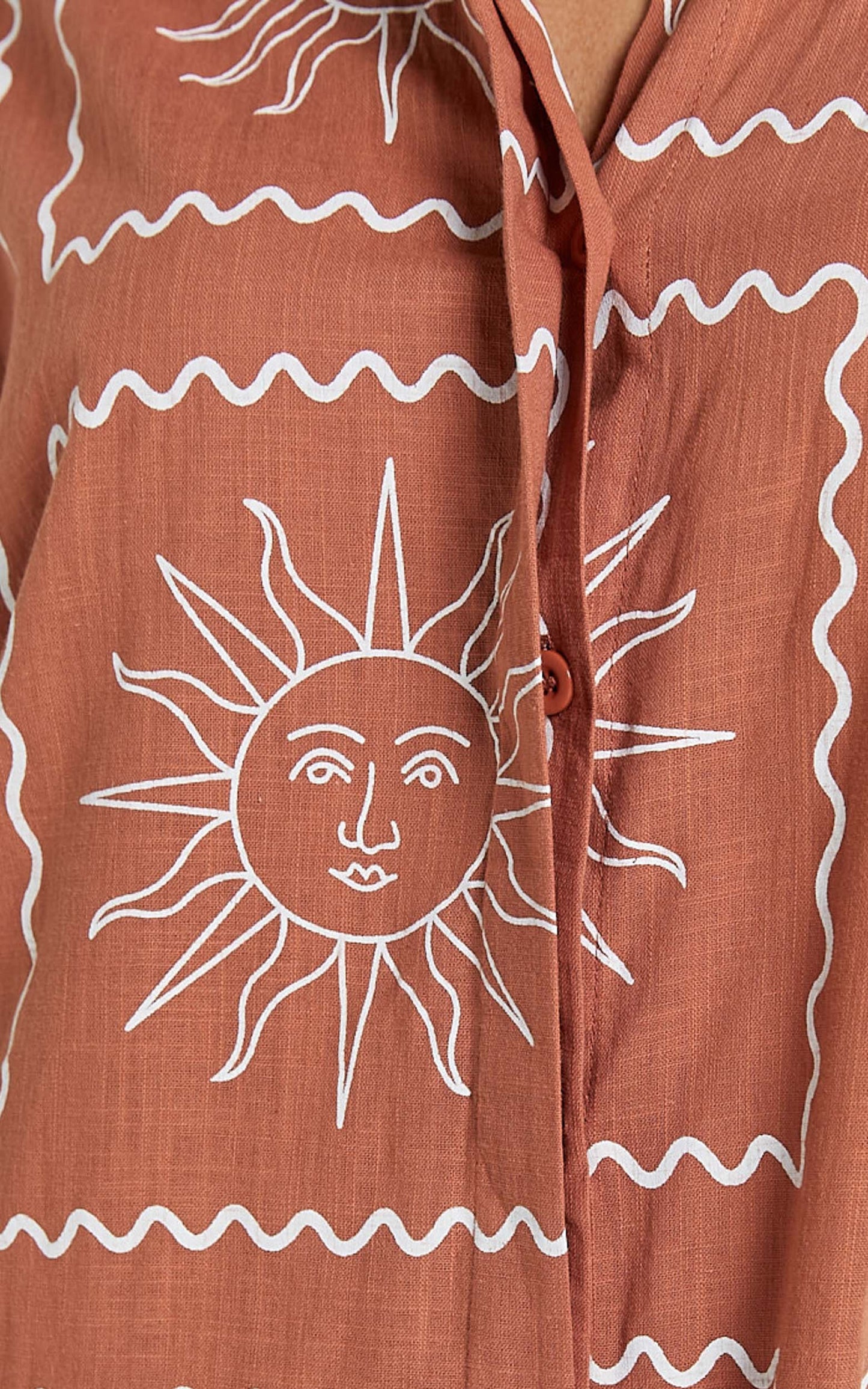 Amarie Playsuit- Short Sleeve Relaxed Linen Button Up Playsuit in Rust Sun Print