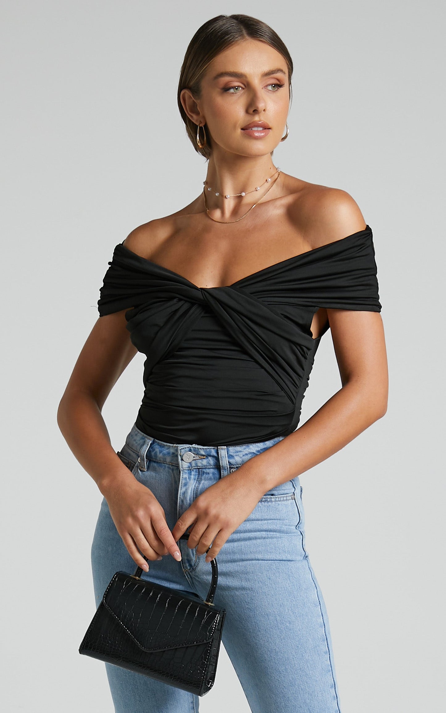 Greita Bodysuit - Twist Front Off Shoulder Bodysuit in Black