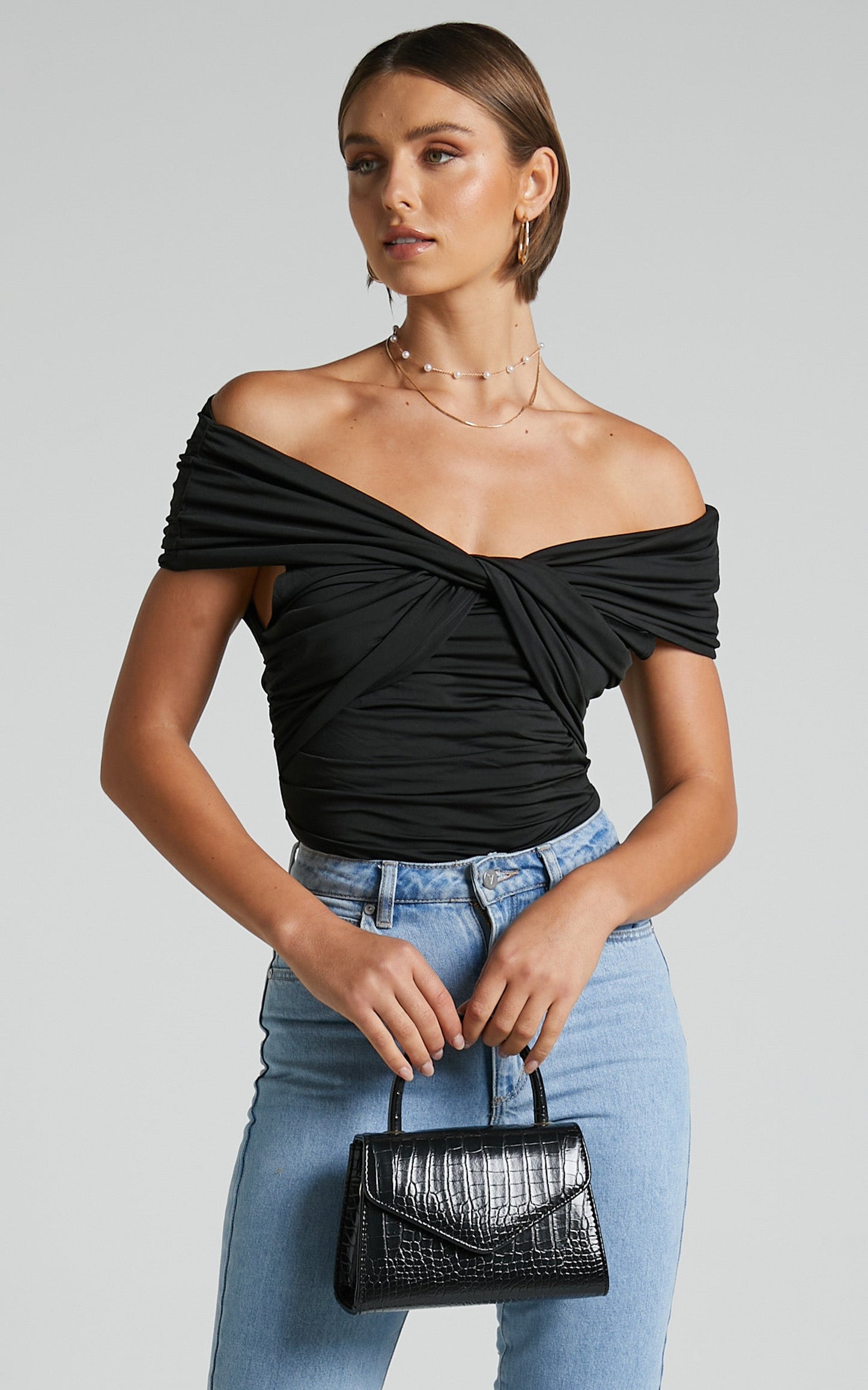 Greita Bodysuit - Twist Front Off Shoulder Bodysuit in Black