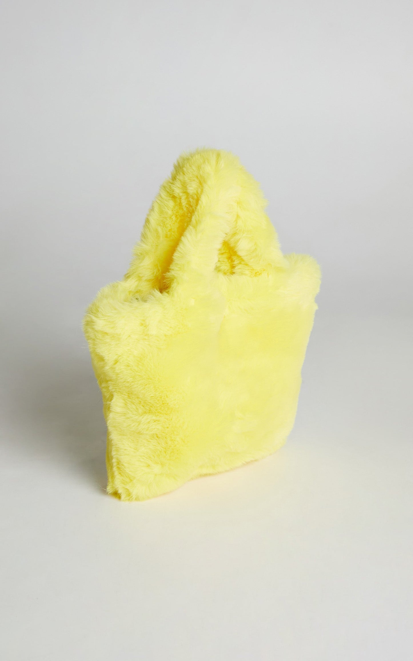 Jamiyah Faux Fur Smiley Face Bucket Bag in Yellow