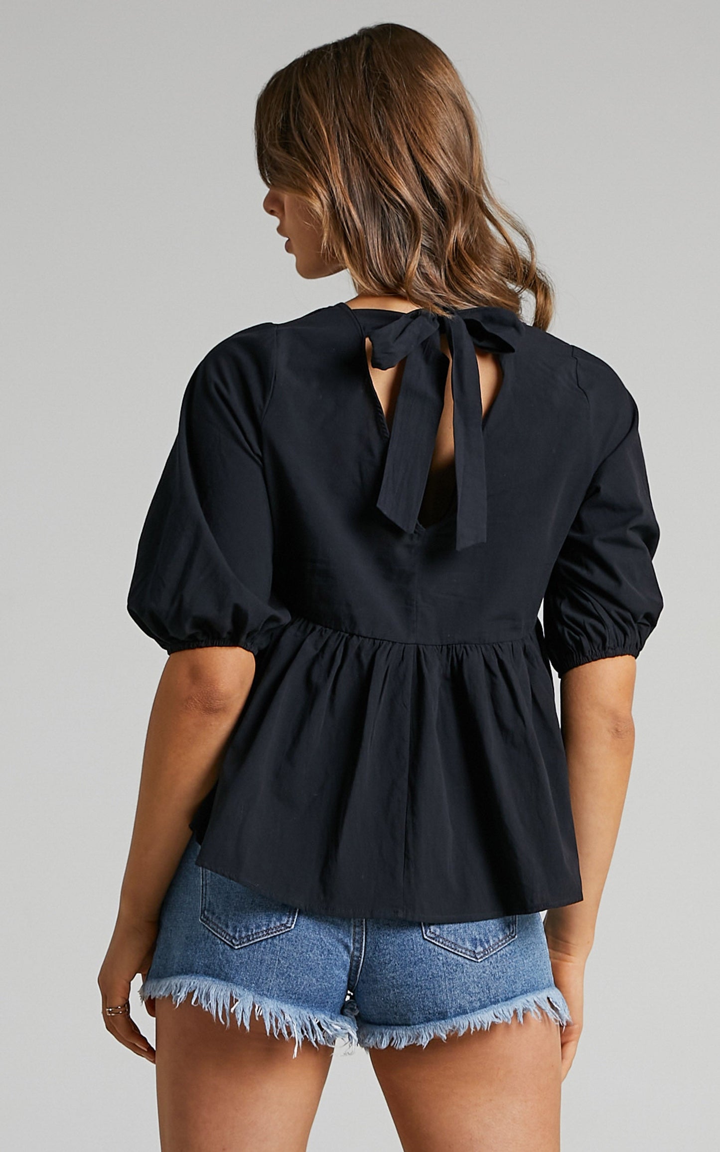 Lallen Smock Top with Peplum Hem in Black