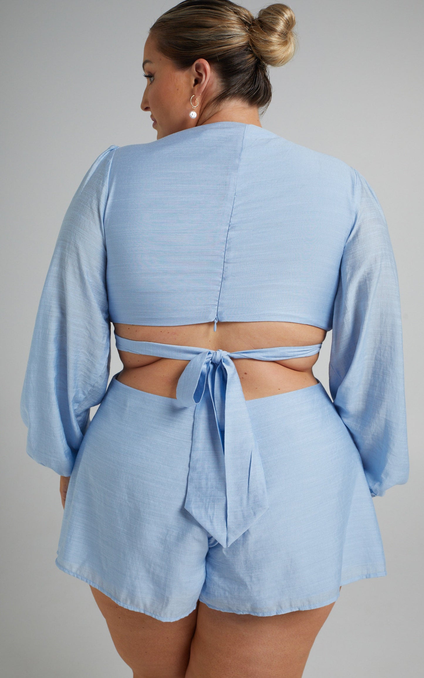 Primrose Cut Out Tie Back Long Sleeve Playsuit in Blue